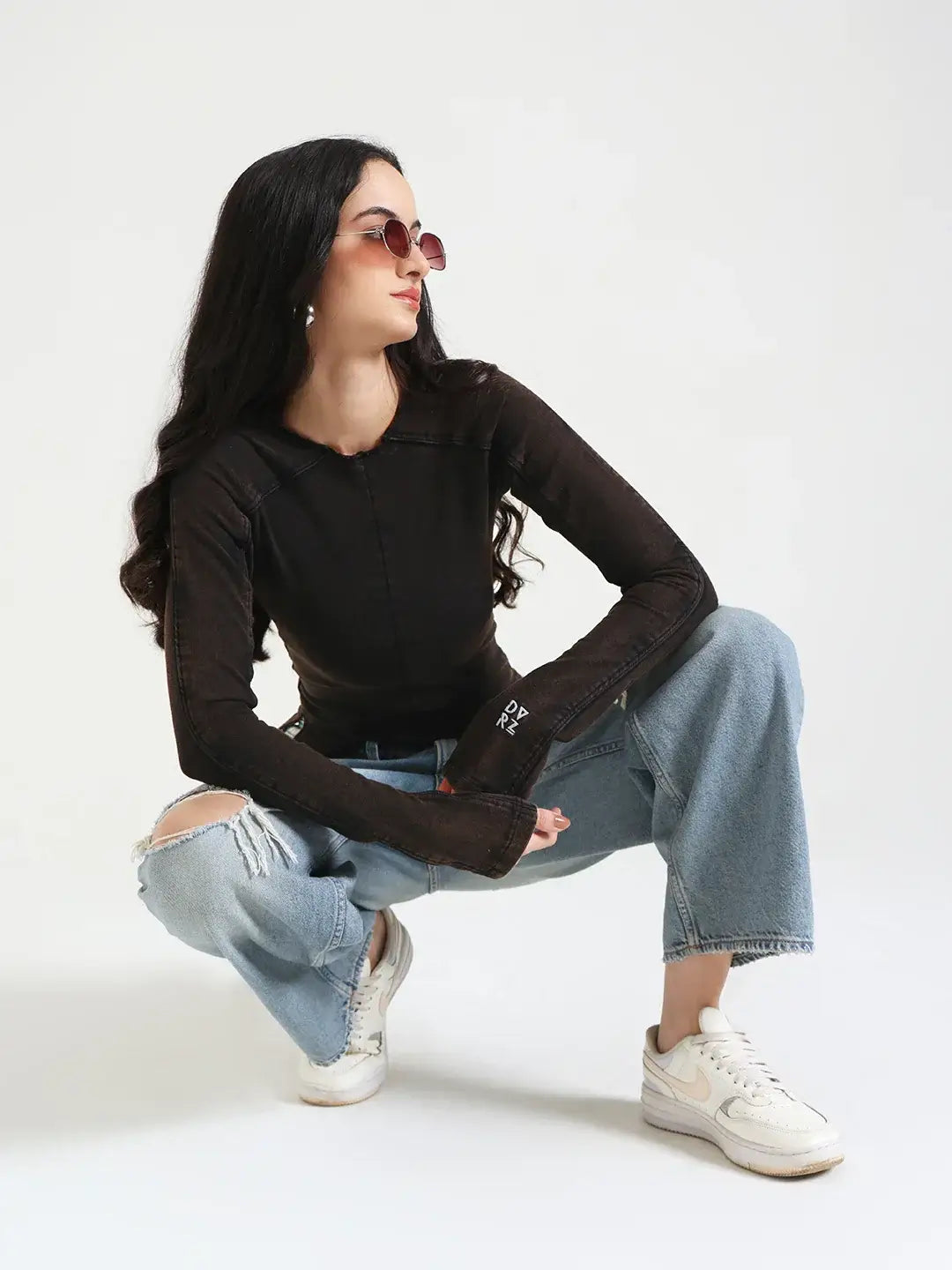 Image of a woman wearing a vintage brown Flared Long Sleeve Top against a neutral background