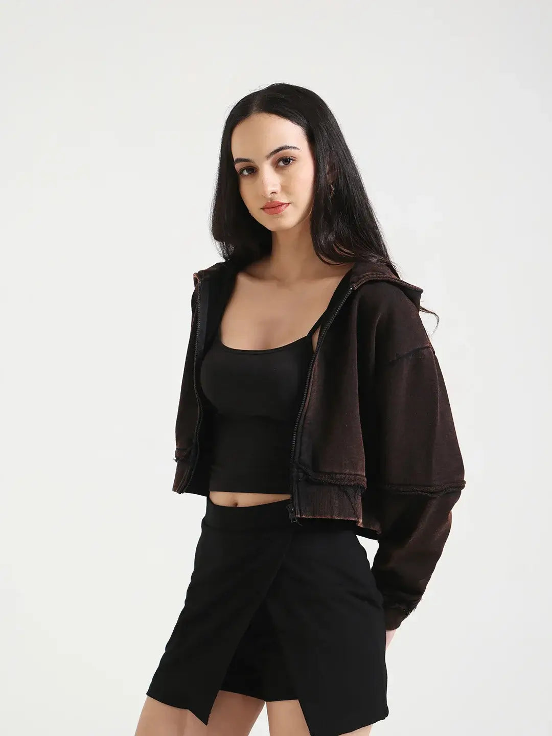 Model wearing a Vintage Brown Cropped Jacket with a black skirt against a grey background