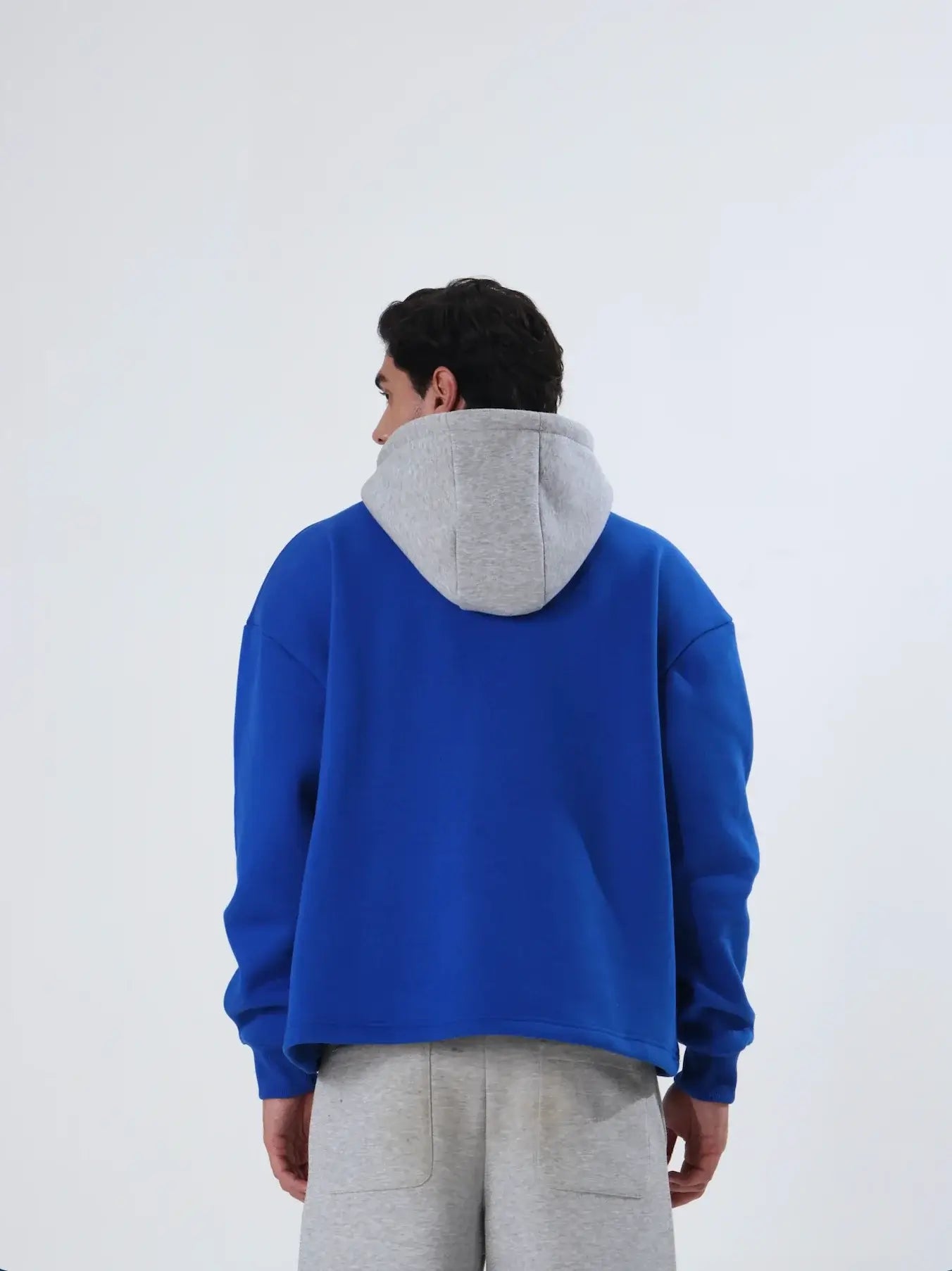 The Blue-Red Hoodie for Men showcased on a model, featuring a blue color and relaxed fit.