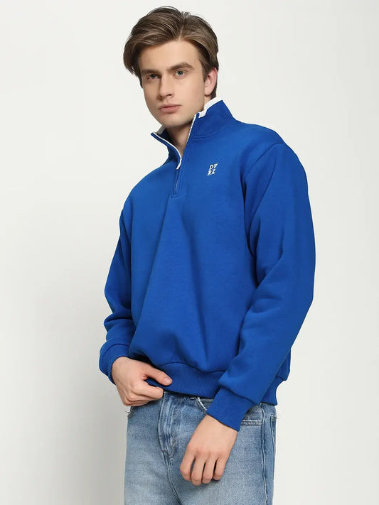 Model wearing DVRZI's Blue Quarter Zip Sweatshirt, showcasing its soft fleece fabric and ribbed cuffs.